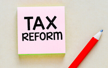 TAX REFORM a word on a small piece of paper. Concept for business.