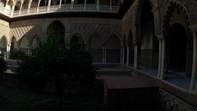 Seville, Spain, September 12, 2021: TILT SHOT - The Royal Palace of Seville (Real Alcazar). The Maidens Courtyard. The Mudejar of Pedro I on the ground floor and the Renaissance of the first monarchs.