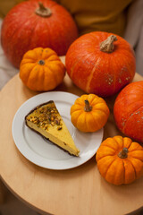 pumpkin pie with pumpkins on wooden table at cafe terrace