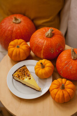 pumpkin pie with pumpkins on wooden table at home 