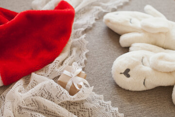 christmas gift box, red santa hat and white mittens for winter holidays