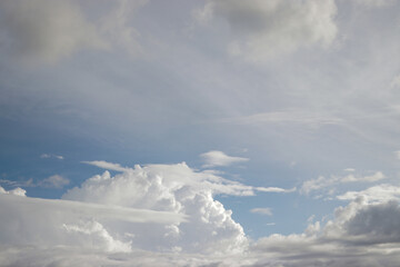 Cumulus clouds with a clear blue sky background in the midday. Types of clouds stock images.