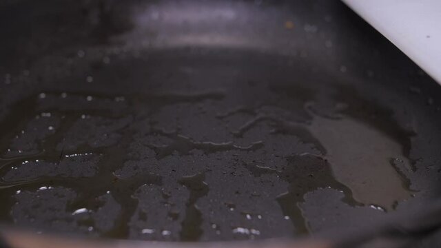 frying broccoli on oil fry pan slow motion