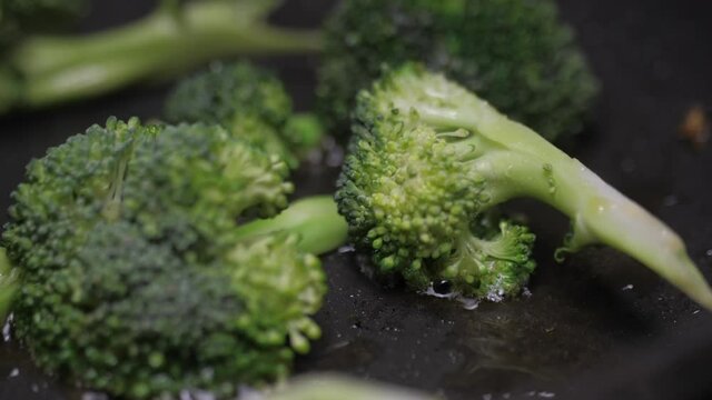 frying broccoli on oil fry pan slow motion