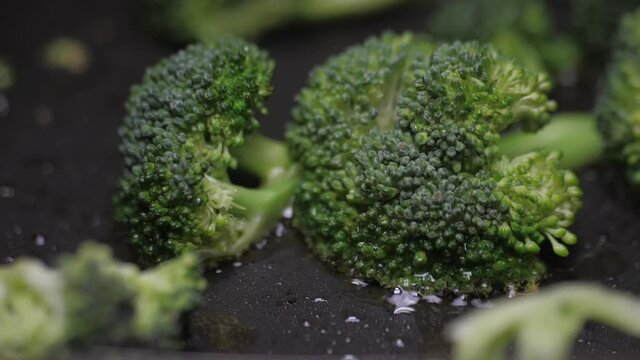 frying broccoli on oil fry pan slow motion