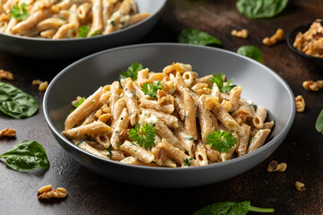 Whole Wheat Penne pasta with gorgonzola cheese sauce, spinach and walnut. Healthy food. - Powered by Adobe