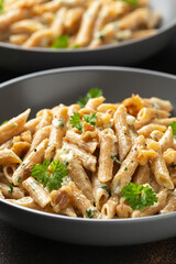 Whole Wheat Penne pasta with gorgonzola cheese sauce, spinach and walnut. Healthy food.