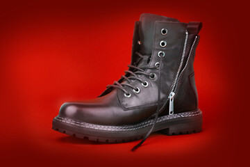 Black boots isolated on red bacground