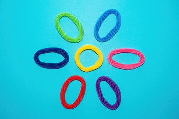 Top view of multicolored scrunchies, elastic hair ties, cotton hair ponytail holders, seamless hair bands