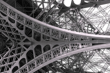 Eiffel tower structure black and white with birds in the sky.