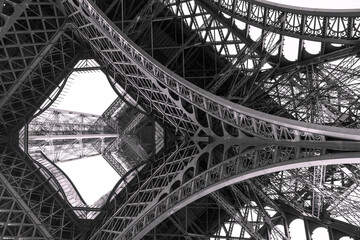 Eiffel tower structure black and white with birds in the sky. - Powered by Adobe