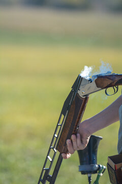 Shotgun smoking after removing an empty from a trap, skeet, five stand or sporting clays shotgun.