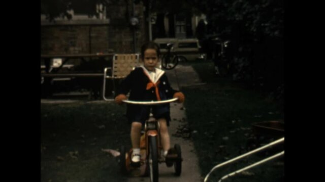Riding Tricycle 1962 - A girl rides a tricycle.  