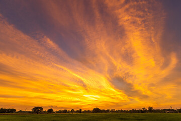 Twilight blue bright and orange yellow dramatic sunset sky in countryside or beach colorful cloudscape texture with white clouds air background.
