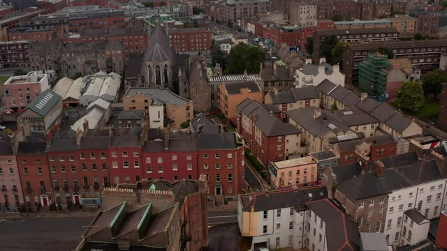 Aerial panoramic view of town. Tilt down footage to residential buildings. Limited visibility due to mist or smog. Dublin, Ireland