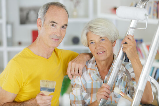 happy senior couple doing diy