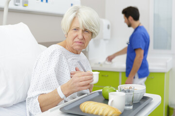 senior woman in hospital disliking the medical center meal