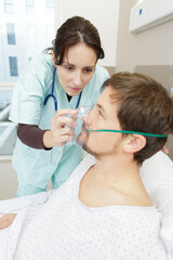 nurse placing oxygen mask on male patient