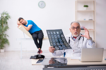 Young male patient visiting old male doctor radiologist