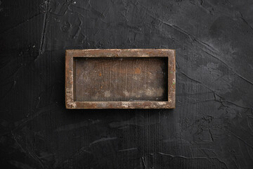 Rustic wooden box or container with copy space for text or food, top view flat lay , on black dark...