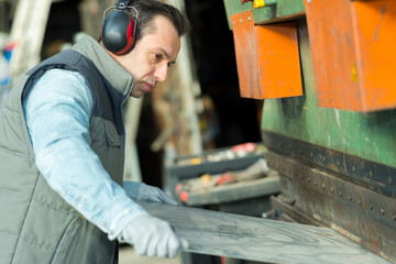 worker in a hardhat working at the metal factory