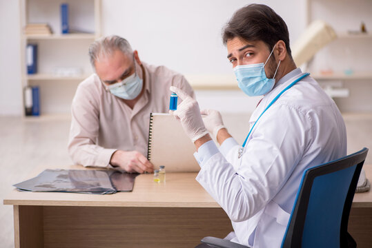 Old male patient visiting young male doctor in vaccination conce