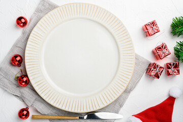 Christmas table setting with vintage dishware and decoration, top view flat lay , with copy space for text or food, on white stone table background
