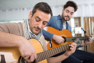 Obraz premium two men rehearsing with acoustic guitars