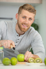 Fototapeta premium happy man cutting organic apples