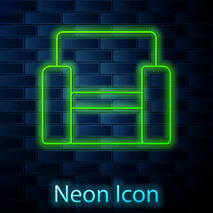 Glowing neon line Cinema chair icon isolated on brick wall background. Vector