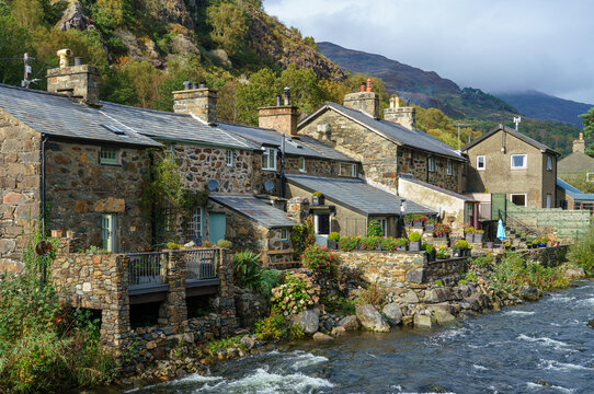 village cottages constructed in local dark stone from the 18th century on the afon Colwyn in Beddgelert, Caernarfon Snowdonia, Wales UK