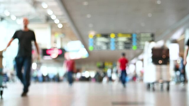 blurred image people tourists with luggage walking at the airport travel concept. High quality 4k footage