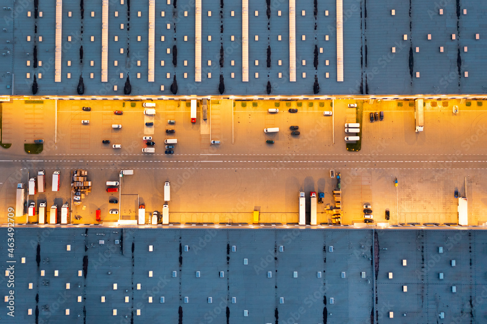 Wall mural aerial view of cars waiting to be unloaded at the logistics warehouse, night view of the industrial 