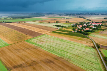 Summer landscape with a thundercloud over fields and forests, view from above