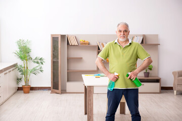 Old man cleaning the house