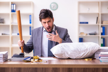 Young male employee in oversleeping concept