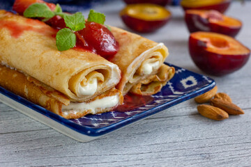 Pancakes with vanilla yogurt and stewed plums.