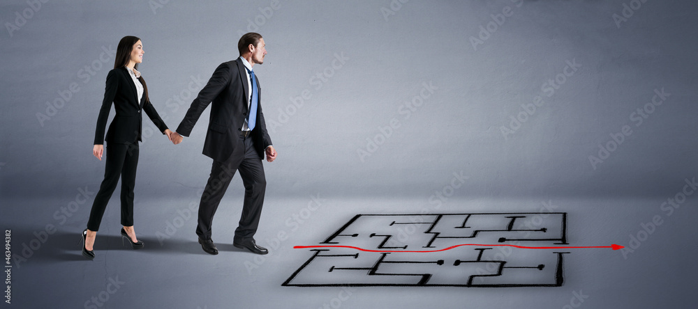 Poster attractive young european businessman and woman walking in concrete interior with red arrow through 