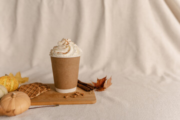 Coffee Take Away Cup in Autumn Pumpkin Set Up. Pumpkin spice latte with whipped cream and fresh...