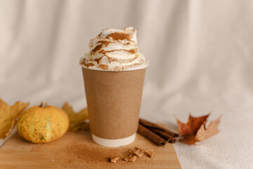 Coffee Take Away Cup in Autumn Pumpkin Set Up. Pumpkin spice latte with whipped cream and fresh...