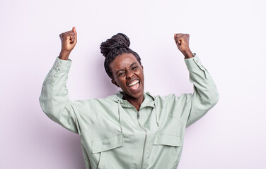 black pretty woman shouting triumphantly, looking like excited, happy and surprised winner,...