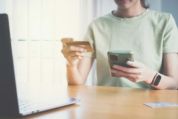 Woman enjoy with online shopping application and typing credit card for fill number to payment