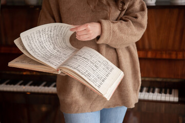 Close-up of musical notes in female hands.