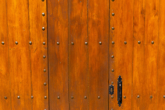 Old wooden door with iron handle