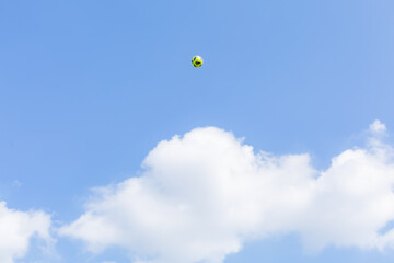 a soccer ball kicked in the blue sky in autumn  showa kinen park, tachikawa city