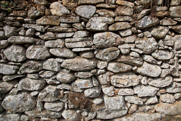Rough texture of the ancient natural stone wall