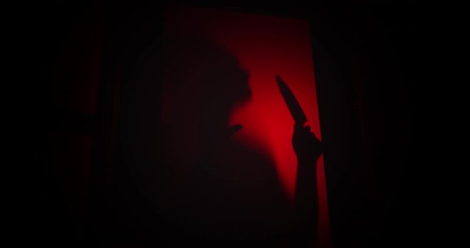 Spooky killer shadow with a knife