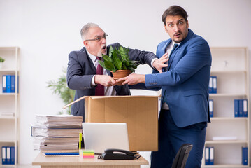 Two male employees in dismissal concept