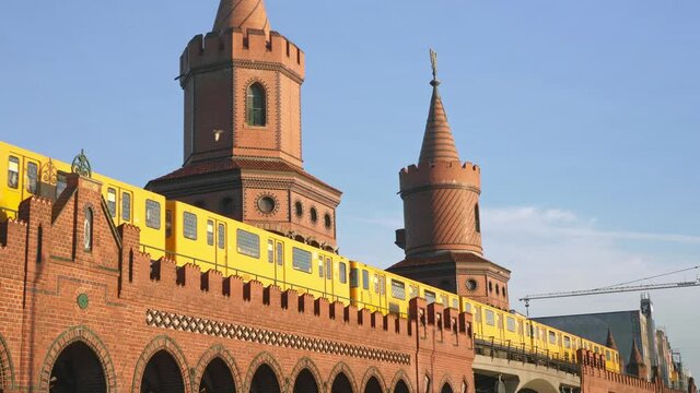 U-Bahn yellow metro train on Oberbaum Bridge in Berlin. Popular landmark, historic tourism destination in Germany.