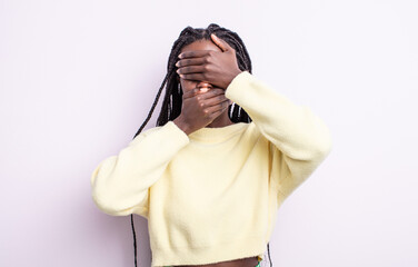 black pretty woman covering face with both hands saying no to the camera! refusing pictures or...